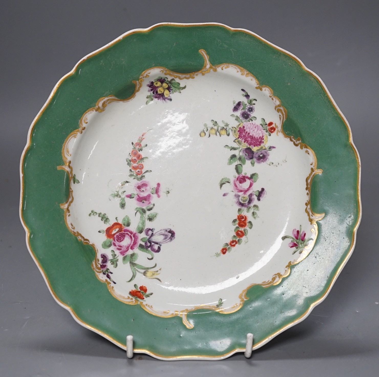 A Worcester plate with apple green border, painted wih two large sprays of flowers and three flower sprigs, known as the Marchioness of Huntly service, see Worcester Porcelain Zorensky, Collection, page 220, plate 252 fo